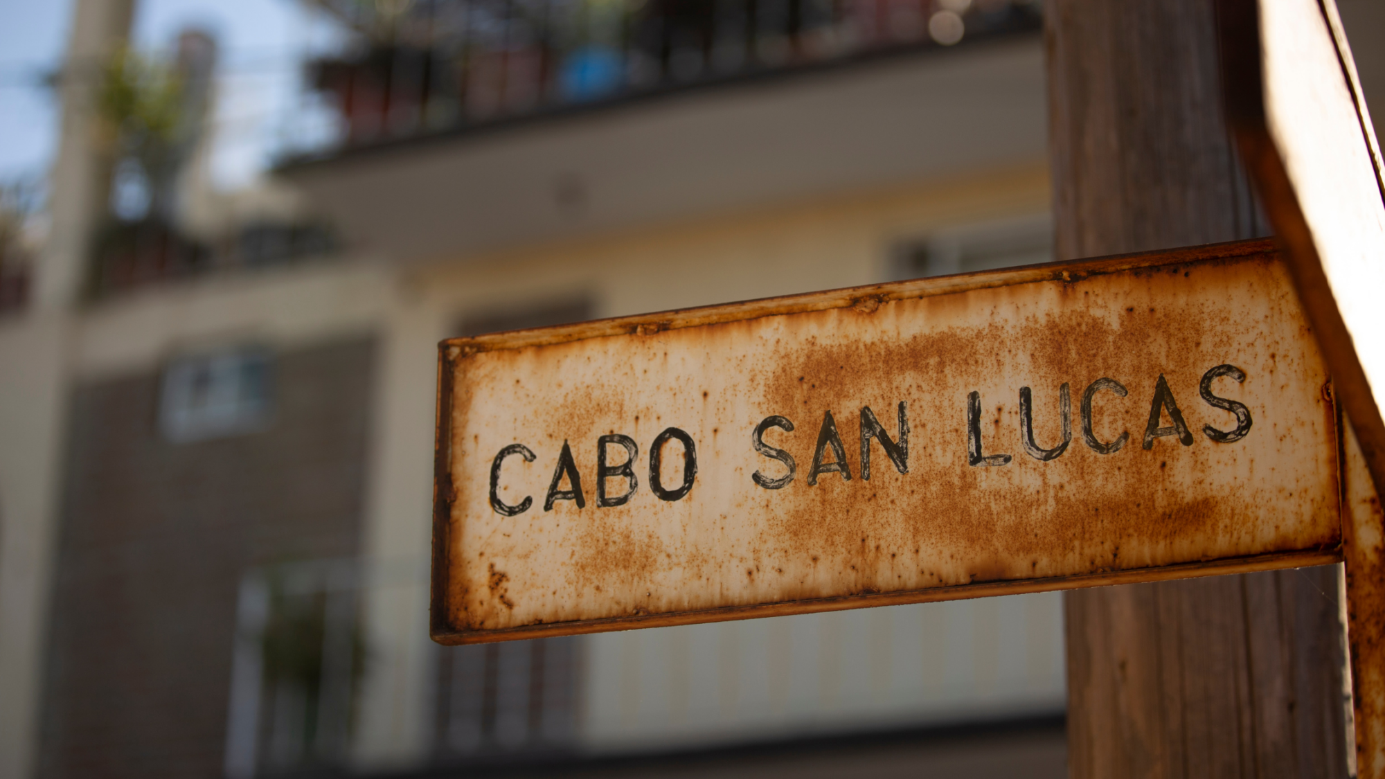 Rustic sign with 'Cabo San Lucas' written on it, showcasing the charm of Cabo’s local style.