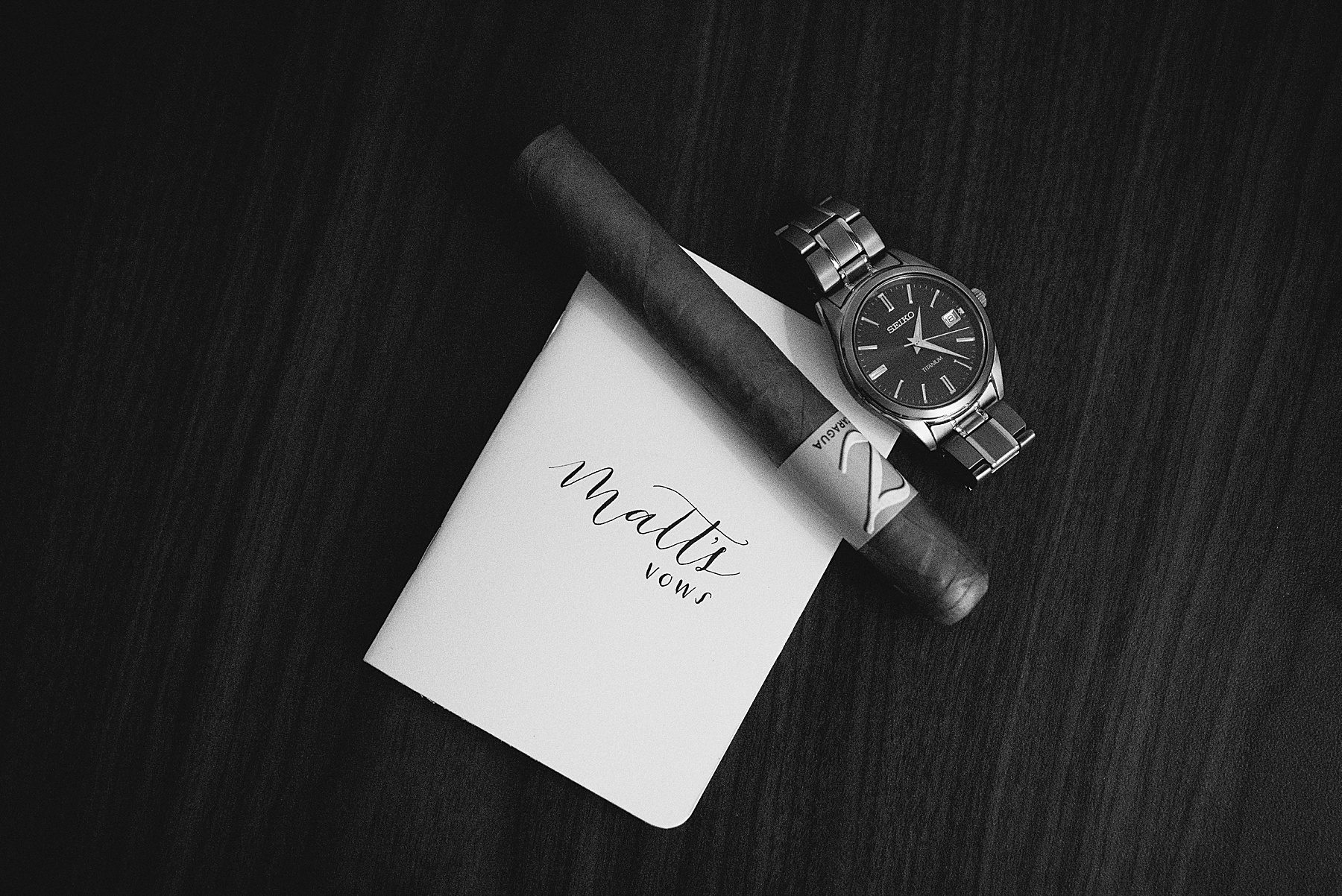 Groom's Vow Book with his watch and cigar placed on top of it for a SLO Wedding.