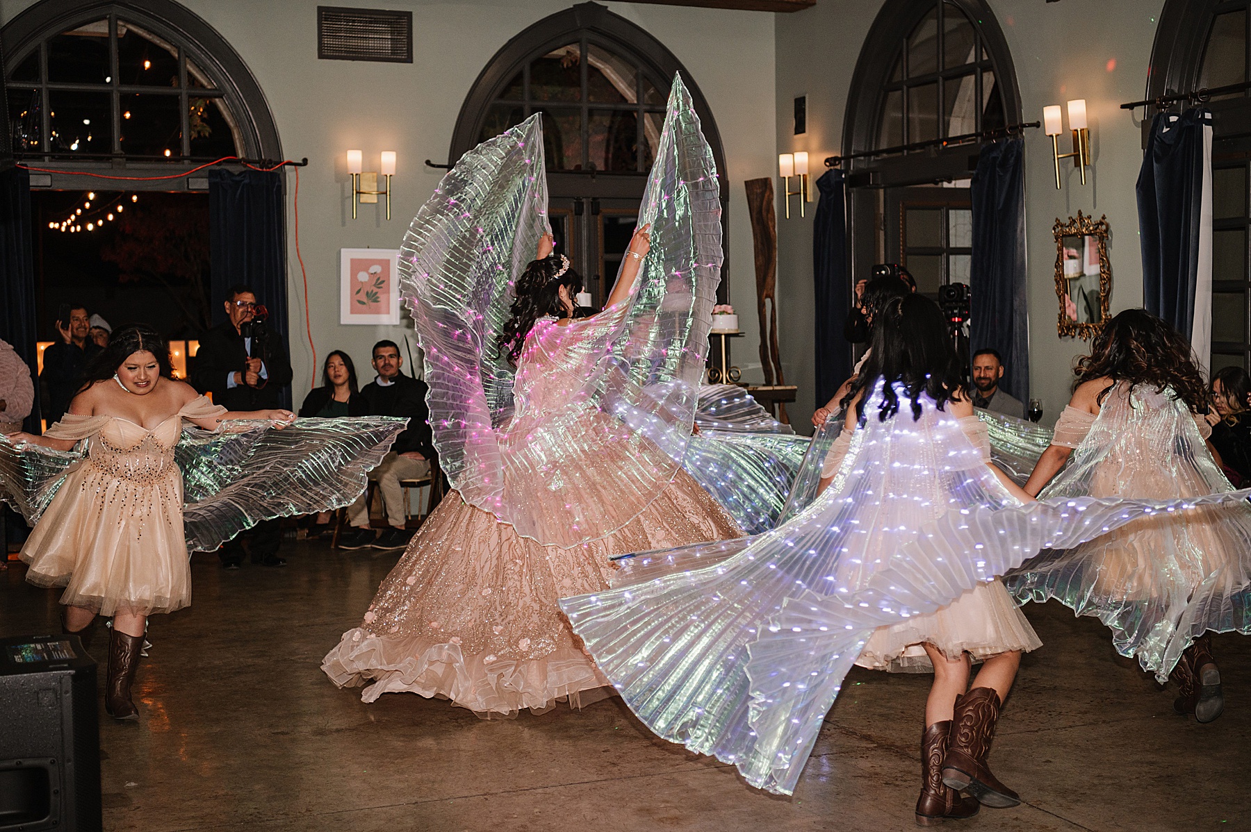 Young women perform a dazzling light-up dance during a Tooth + Nail Winery Quinceañera celebration.