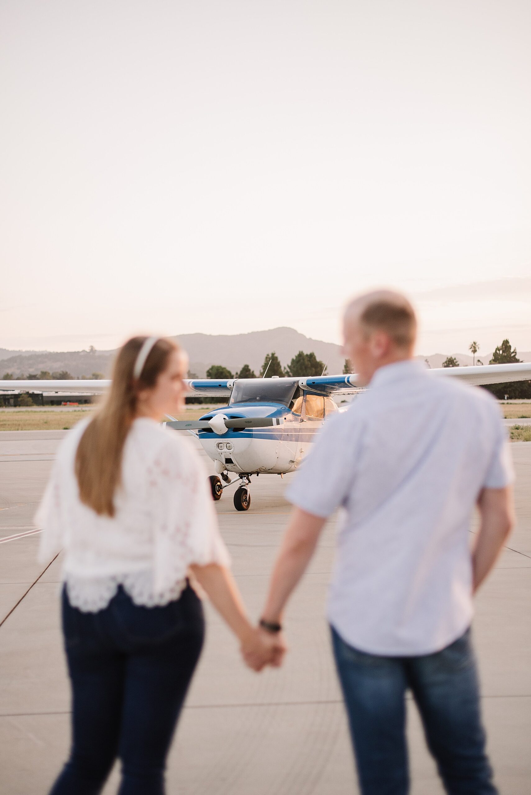 Celebrate love taking flight in this stunning SLO engagement session featuring a commuter plane at the San Luis Obispo airport.