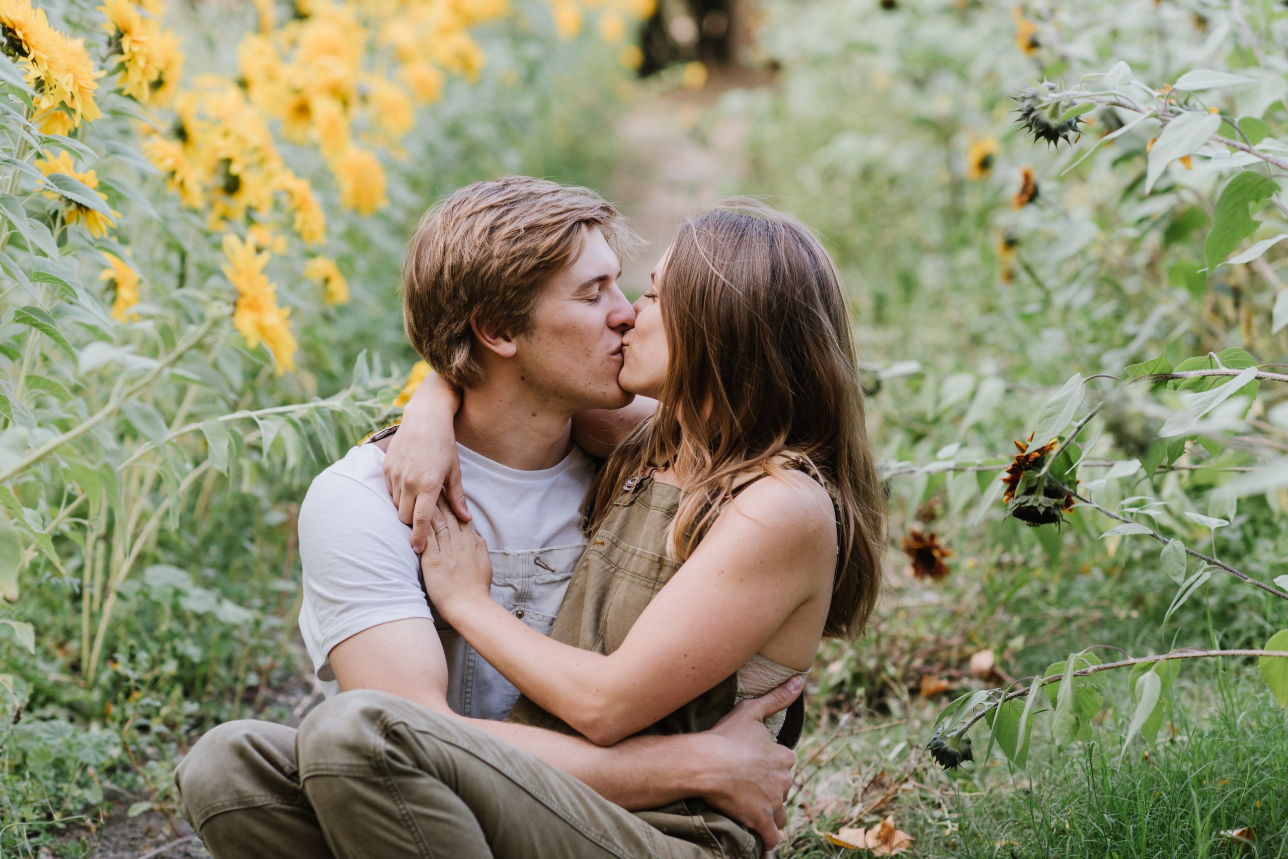Man and Woman kissing in sunflower field