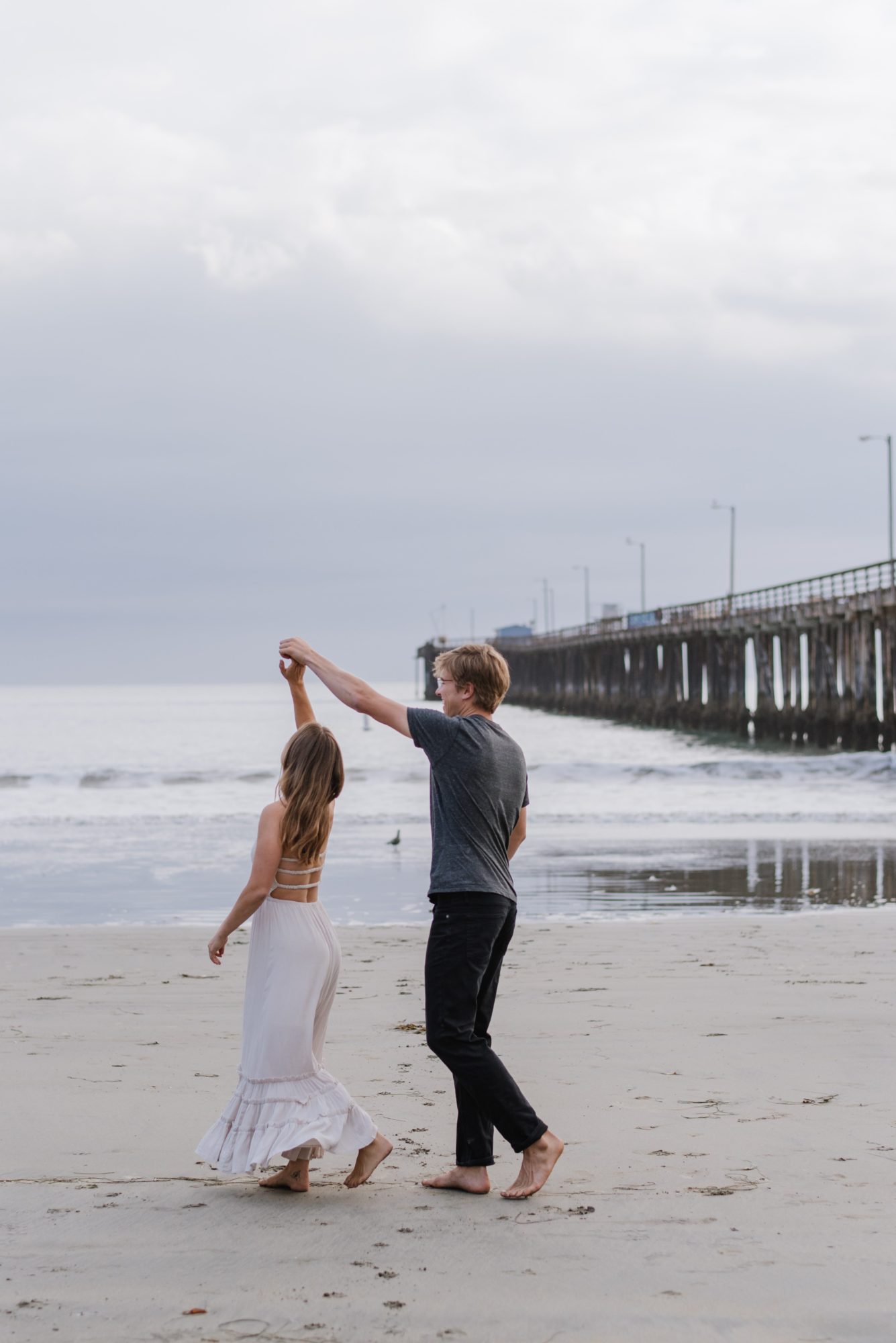 Man twirling woman during engagement session